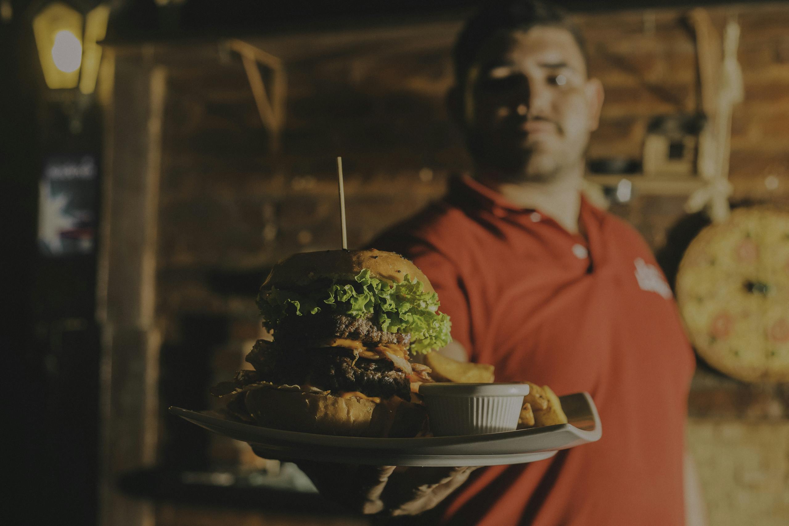 Delicious gourmet burger with fries served indoors at a restaurant in Brazil.